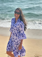 Vilagallo blue white tropical print mini dress worn on beach
