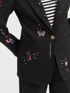 Vilagallo black embroidered blazer close-up showing colourful motifs and gold button detail 
