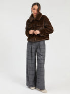 Vilagallo brown faux fur collared jacket styled with grey checked trousers