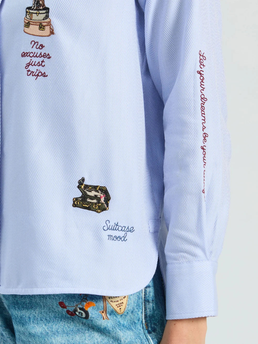 Vilagallo Hotel blue striped shirt with colourful travel embroidery and slogan detail – close-up view