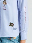Vilagallo Hotel blue striped shirt with colourful travel embroidery and slogan detail – close-up view