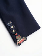 Vilagallo navy blazer close-up showing decorative cuff buttons and embroidery