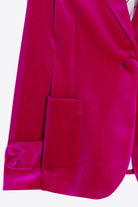 Vilagallo fuchsia velvet blazer close-up showing flap pocket and turn-back cuff