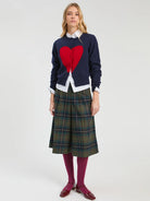 Vilagallo navy red heart cardigan styled with white shirt and checked skirt – full model view