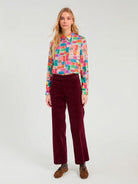 Vilagallo multicolour ticket print long sleeve shirt styled with burgundy trousers